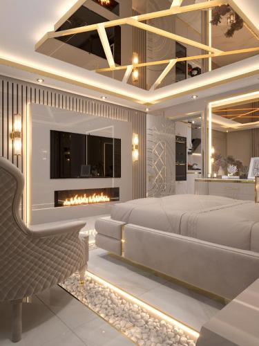 a bedroom with a large bed and a fireplace at Alexandras Palace in Bradford