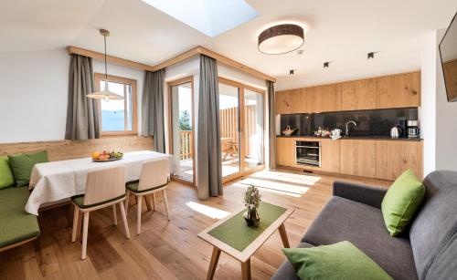 a living room with a couch and a table and chairs at Hoferhof in Maranza