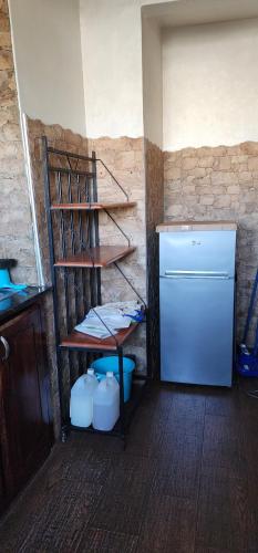 a room with a shelf next to a refrigerator at residence baida in Casablanca
