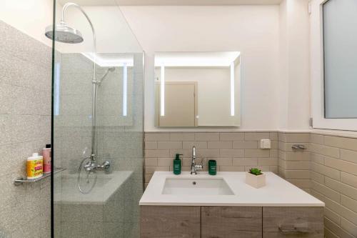 y baño con lavabo, ducha y espejo. en Boutique07 Luxury Apartment, Athens, Acropolis., en Atenas
