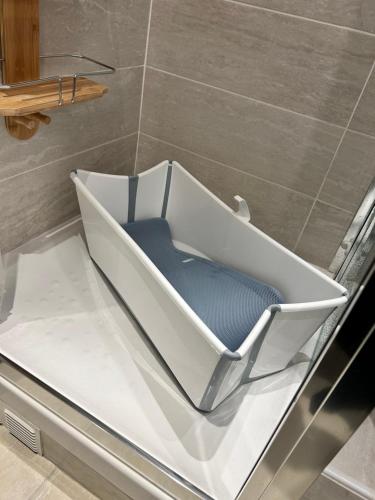 a chair sitting on a bath tub in a bathroom at Roosevelt Cosy 2BR Easy Access to Paris Free parking in Saint-Germain-en-Laye