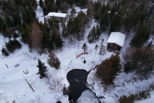 an aerial view of a snow covered forest with a bridge at Chalet Milan in Milan