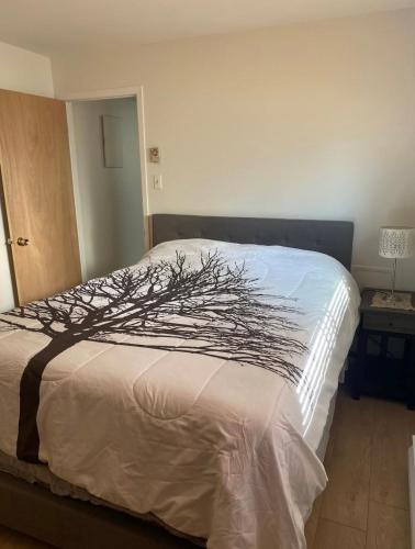 a bedroom with a bed with a tree on it at Heaven Is A Place On Earth in Montreal