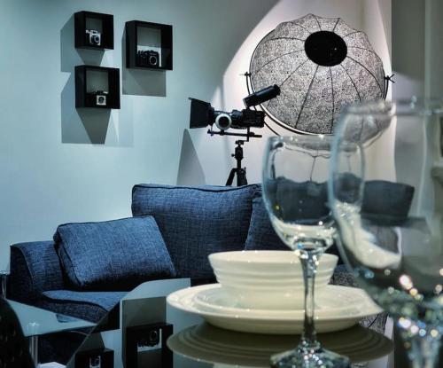 a table with a camera and a wine glass at Two Bedroom Luxury Apt with film style in Swansea