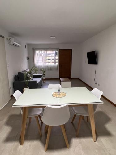 un soggiorno con tavolo e sedie bianchi di Departamento 2 habitaciones planta baja Hasta 4 huéspedes a Tunuyán