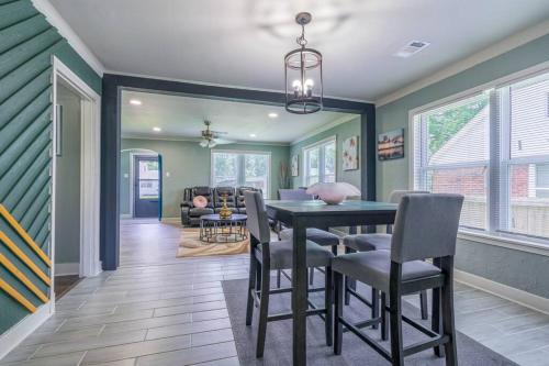 a dining room with green walls and a table and chairs at MIKA SPRINGS Beach Inspired Home! in Memphis