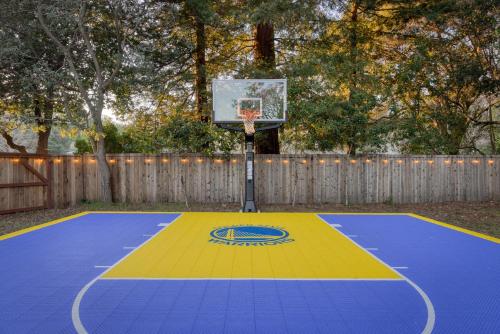 a basketball hoop on a blue and yellow basketball court at Game On! in Novato