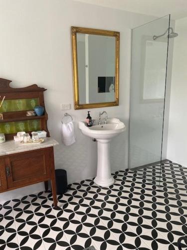 a bathroom with a sink and a mirror at Palmyra B&B in Rainbow Flat