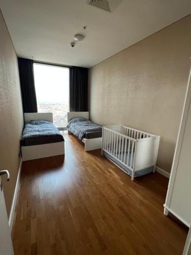 a bedroom with two beds and a crib at Skyland in Istanbul