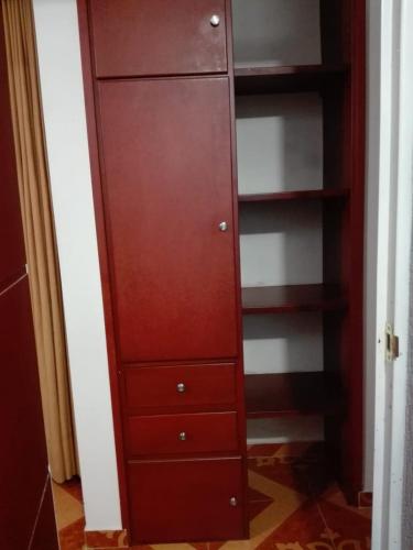 a tall wooden cabinet with drawers in a closet at Posada Turística Estancia Real in Sutamarchán