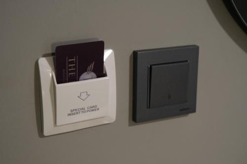 a box with a book and a computer monitor on a wall at The Pearl Airport Hotel in Arnavutköy
