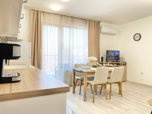 a kitchen and dining room with a table and chairs at Central Apartment for 4 Guests Next to State Opera in Stara Zagora