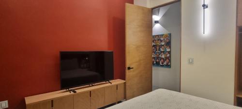 a living room with a television on a wall at CASA DON JULIAN in Oaxaca City