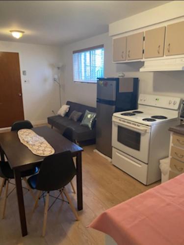 a kitchen and living room with a stove and a table at Heaven Is A Place On Earth in Montréal