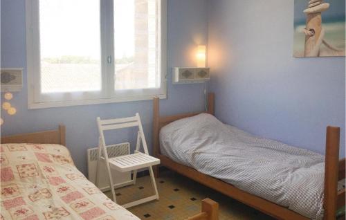 1 dormitorio con 1 cama, 1 silla y 1 ventana en Stunning Apartment In L Aiguillon Sur Mer With Kitchenette, en LʼAiguillon-sur-Mer
