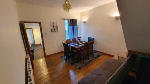 a living room with a dining room table with chairs at Spacious 2 Bedroom Home in Birmingham in Birmingham