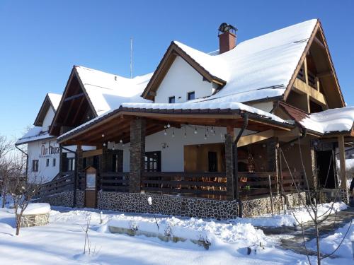 a house with snow on the roof at NUT HOUSE Retezat in Nucşoara