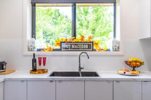 a kitchen with a sink and a window with a mt marion sign at Wotama, Macedon B and B, Honour Ave, Mount Macedon in Mount Macedon