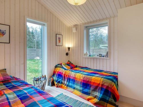 two beds in a room with a window at Holiday home Rørvig XVI in Rørvig