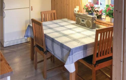 a dining room table with a blue and white table cloth at Lovely Home In Råda With House Sea View in Råda