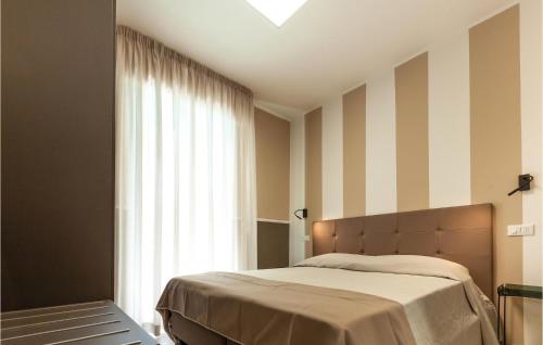 a bedroom with a bed and a large window at Bilo Std in Alba Adriatica