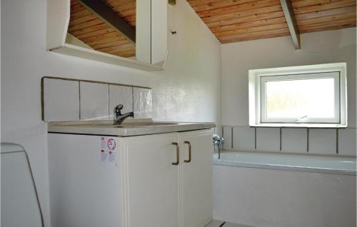 a white bathroom with a sink and a tub at Awesome Home In Ringkbing Dk With Wifi in Søndervig
