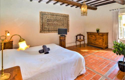 a bedroom with a bed and a dresser and a television at Amazing Home In Mornas in Mornas