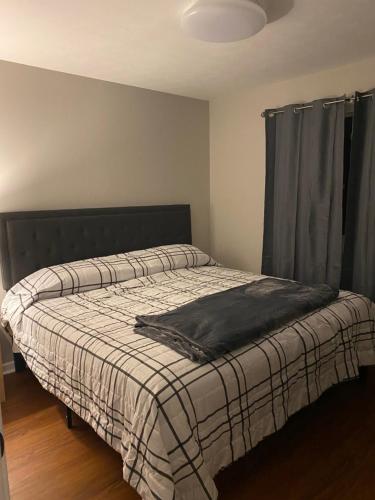 a bedroom with a bed with a blanket on it at Hiker's Retreat modern 3 bedroom home with 2 baths in Travelers Rest