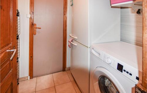 a white refrigerator with a washing machine in a room at 3 Bedroom Gorgeous Home In Intres in Saint-Agrève
