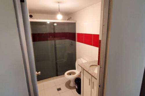 a bathroom with a toilet and a glass shower at Departamento 3 D. Cochabamba in Cochabamba