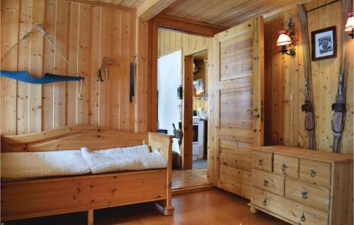 a log cabin bedroom with a bed and a closet at Nice Home In Noresund With 5 Bedrooms And Sauna in Noresund