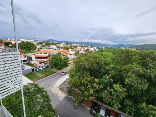a view of a city with a street and trees at Apart Hotel Alecrim Praia de Camboinhas com Marina pe na areia in Niterói