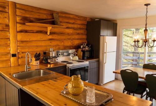 eine Küche mit Spüle und Herd oberen Backofen in der Unterkunft Cozy Lake Loj + Hot Tub & Fire Pit in Huberdeau