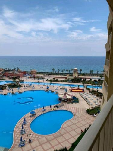 a view of the pool from the balcony of a resort at بورتو السخنة خدمة فندقية in Ain Sokhna