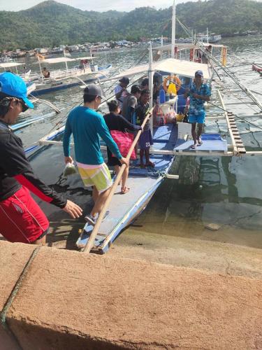 un groupe de personnes sur un bateau dans l'eau dans l'établissement SUN'S TRAVEL AND TOURS AGENCY CORON PALAWAN, à Coron