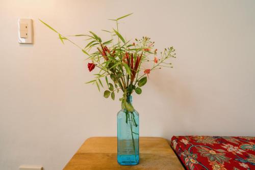 a vase with flowers in it sitting on a table at Hygge Siargao in General Luna