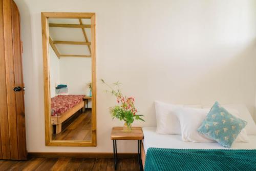 a bedroom with a bed and a mirror at Hygge Siargao in General Luna