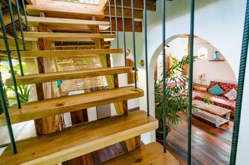 a spiral staircase in a house with a living room at Hygge Siargao in General Luna