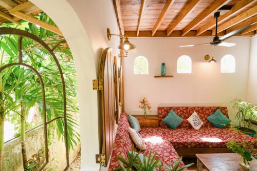 a living room with a couch in a room with windows at Hygge Siargao in General Luna
