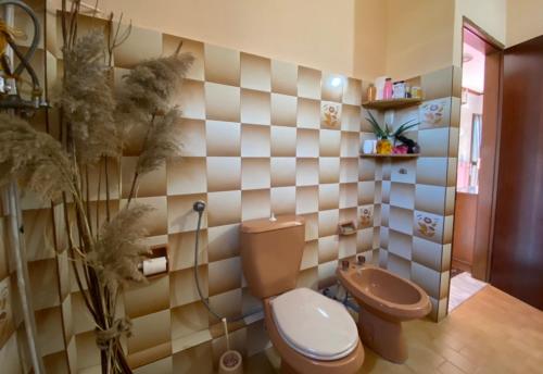a bathroom with a toilet and a shower in it at Olympus Guest Home 