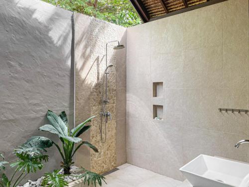 een badkamer met een douche en een wastafel bij Rumah Sunyi in Gili Trawangan