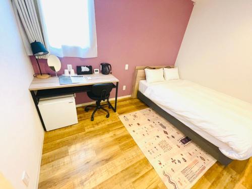 a small bedroom with a bed and a desk at Megu fuji 2021 - Vacation STAY 74539v in Fujiyoshida
