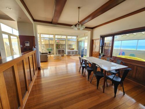 a dining room with a table and chairs at Sandy Shores Estate- Long Island in Frankston
