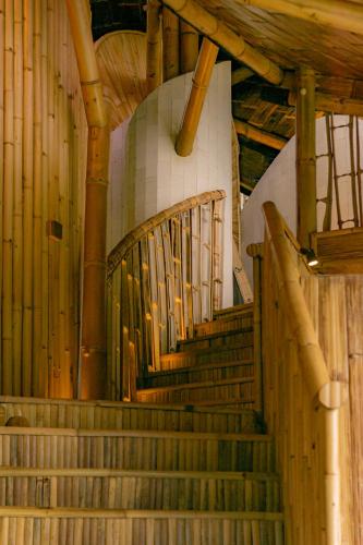 a set of stairs in a building with wooden beams at 3 Bdr - Luxury Cliffside Bamboo Villa in Bungbungan