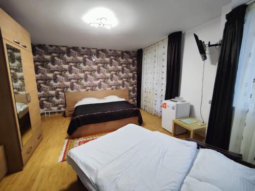 a bedroom with two beds and a wall at Casa Adina in Sinaia