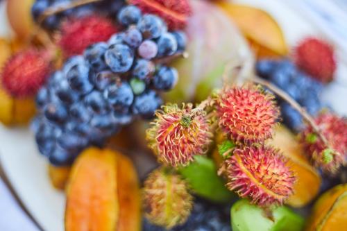 a plate filled with fruit on top at Malika Nungwi Hotel in Nungwi