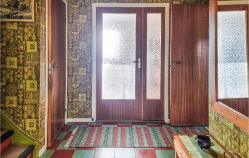 a room with a door with a window and a rug at Lovely Home In Bullaren With Wifi in Bullaren