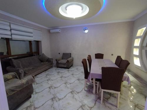 a living room with a table and a couch at Guest house in Qabala in Gabala