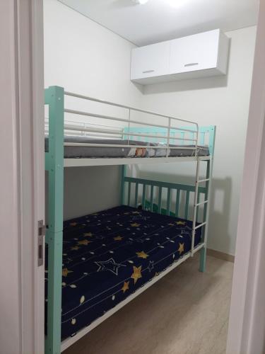 a bunk bed with a blue bunk bed with stars on it at Apartment Podomoro City Deli Medan in Medan