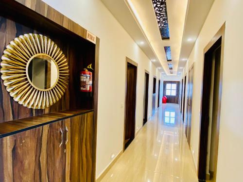 a hallway in a building with a mirror on the wall at Gange Blossam, Haridwar in Haridwār